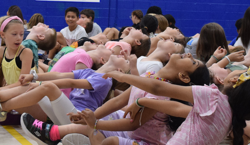 Children of the Danville Vicariate say good morning to heaven as part of the Totus Tuus morning “pump up” at Schlarman Academy on June 21. (The Catholic Post/Paul Thomas Moore)