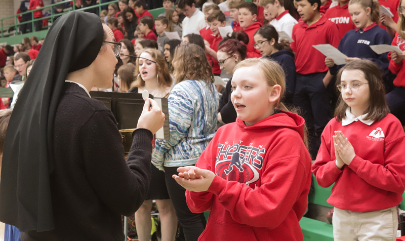 Seton Catholc School student Macy DeMeulenaere receives Communion from Sister M. Bernadette, FSGM, at the Catholic Schools Week Mass hosted by Alleman High School in Rock Island on Feb. 3. (The Catholic Post/Jennifer Willems)