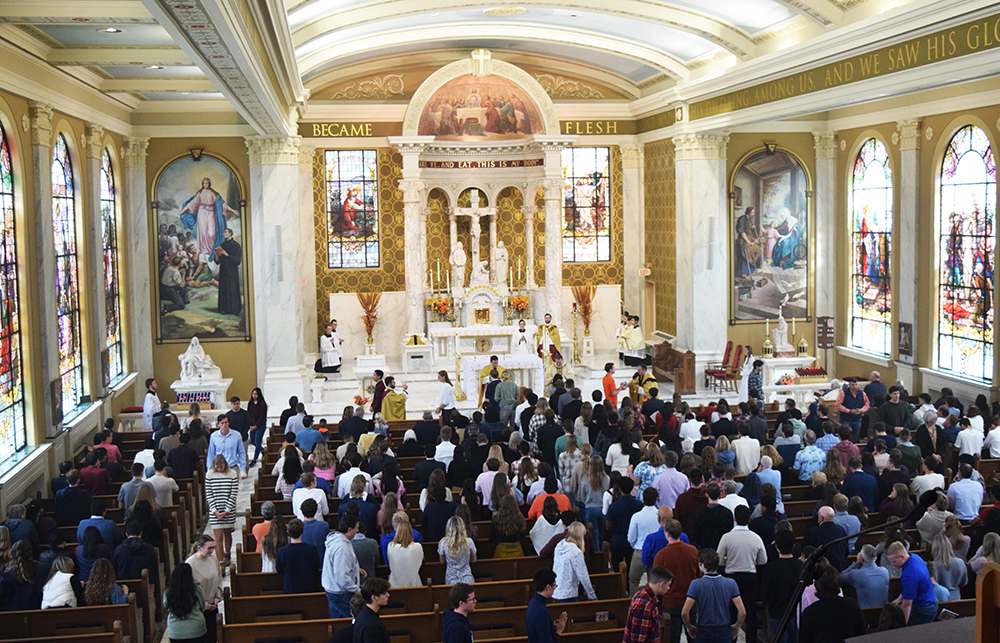 The newly renovated interior of St. John’s Catholic Chapel at the University of Illinois in Urbana-Champaign is seen from the choir loft as those who filled it for the Oct. 8 Mass of Blessing come forward for Communion. (The Catholic Post/Tom Dermody)